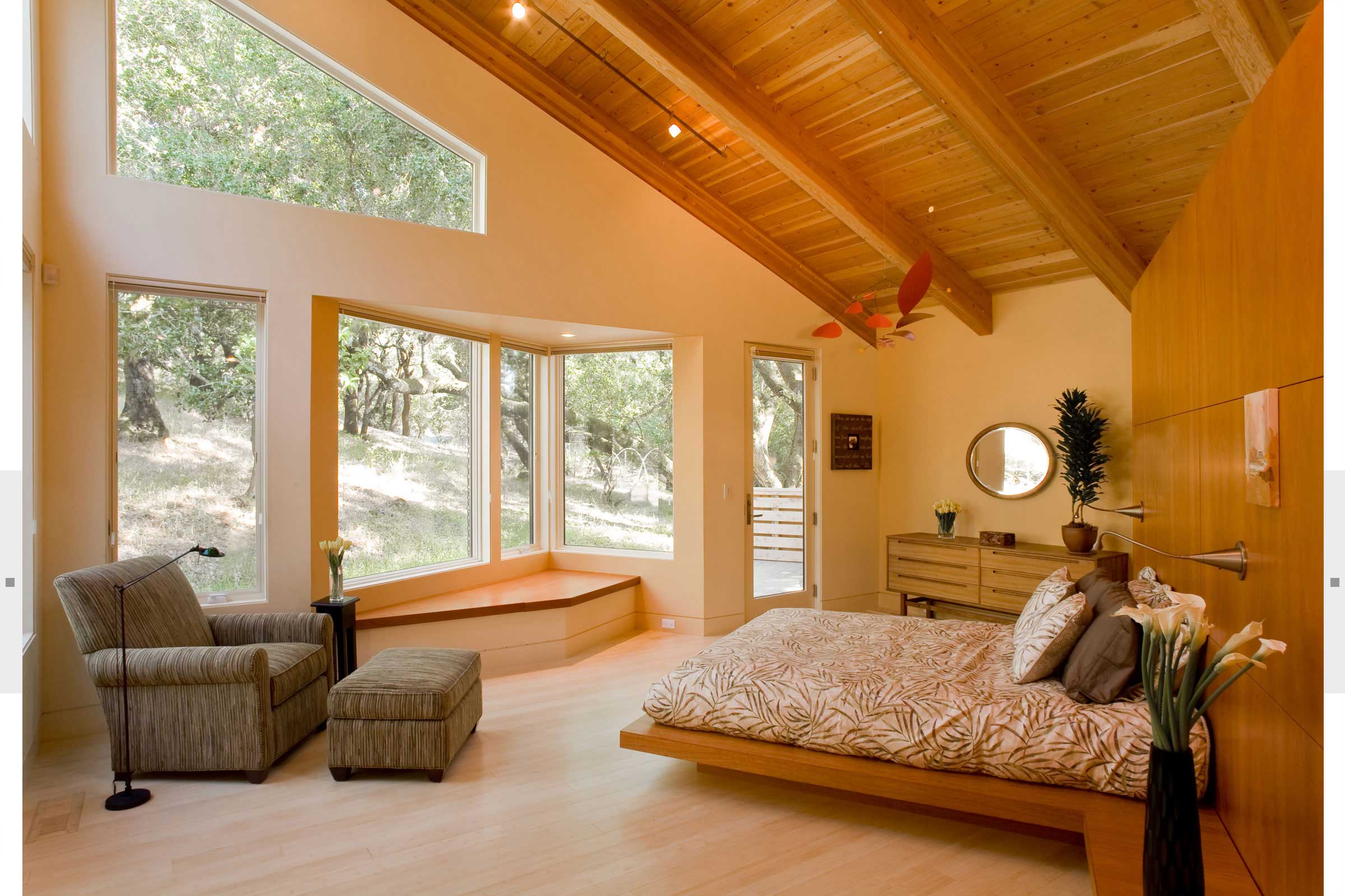 bedroom with large wood wall and expansive windows