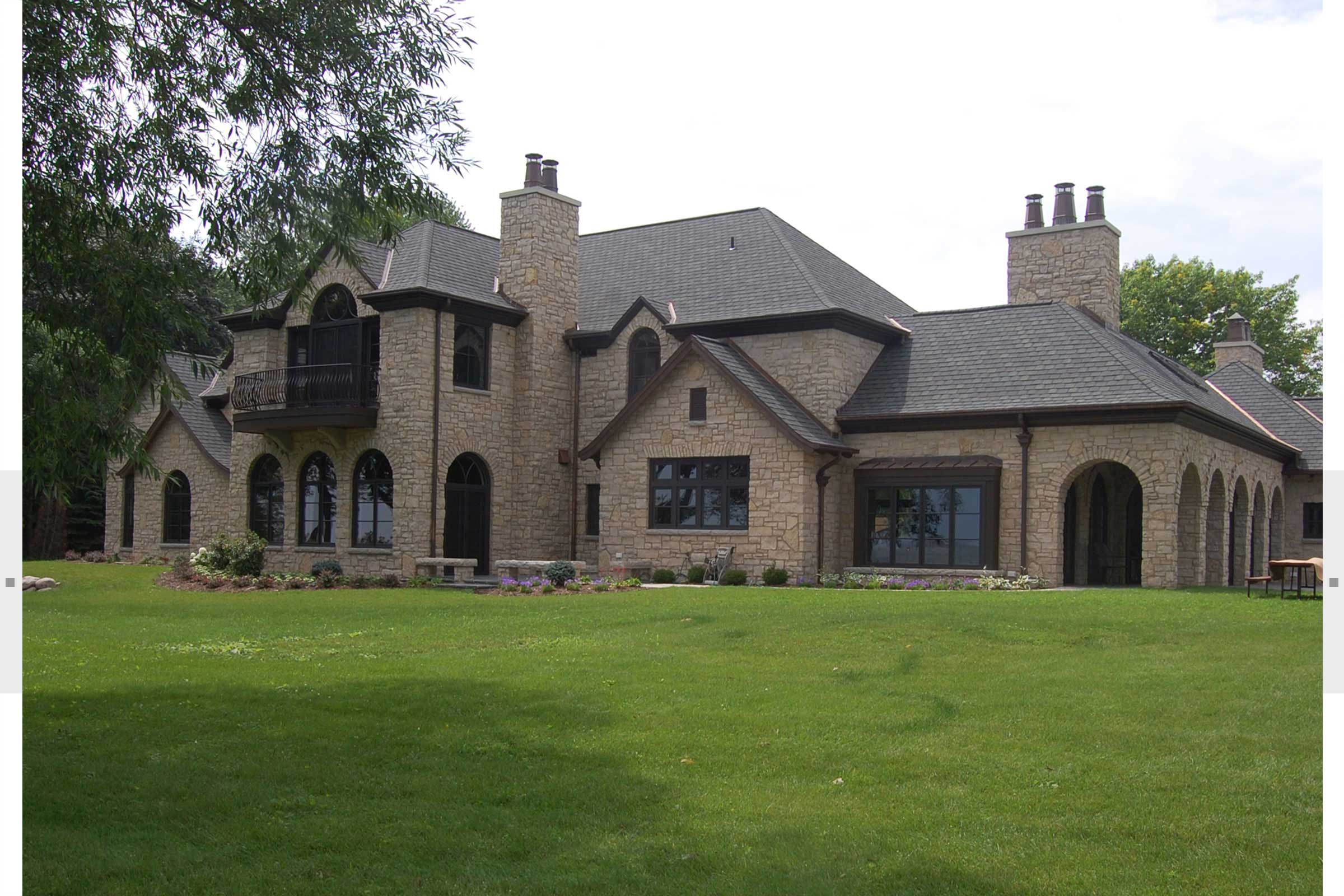 large home with stone facing and balcony