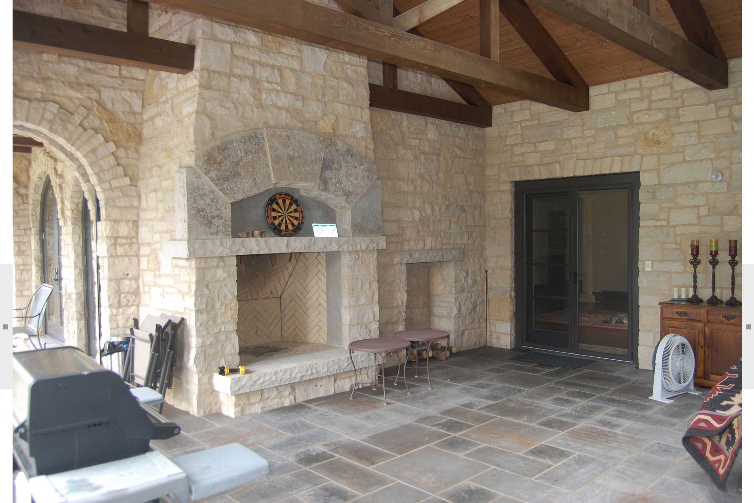 large fireplace in home with beamed ceilings