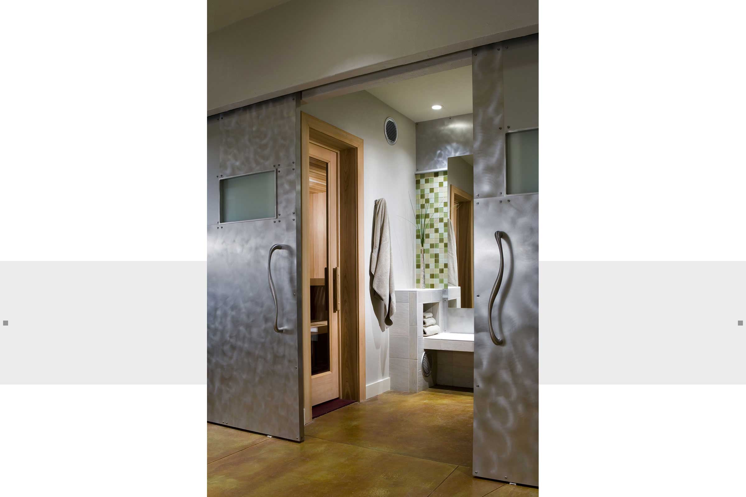 sliding brushed stainless doors to bathroom and sauna