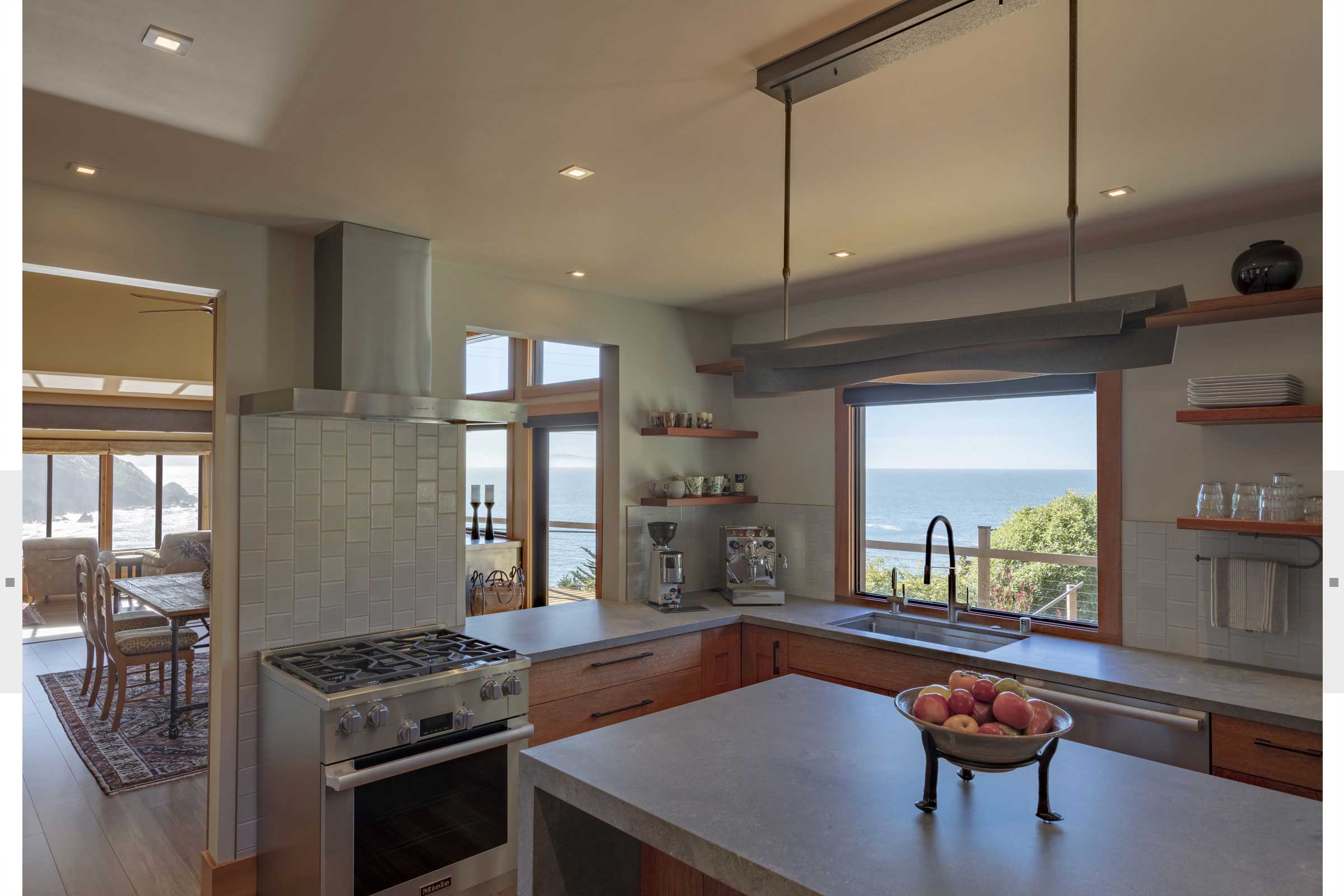 kitchen with custom light fixtures and kitchen details with view of ocean