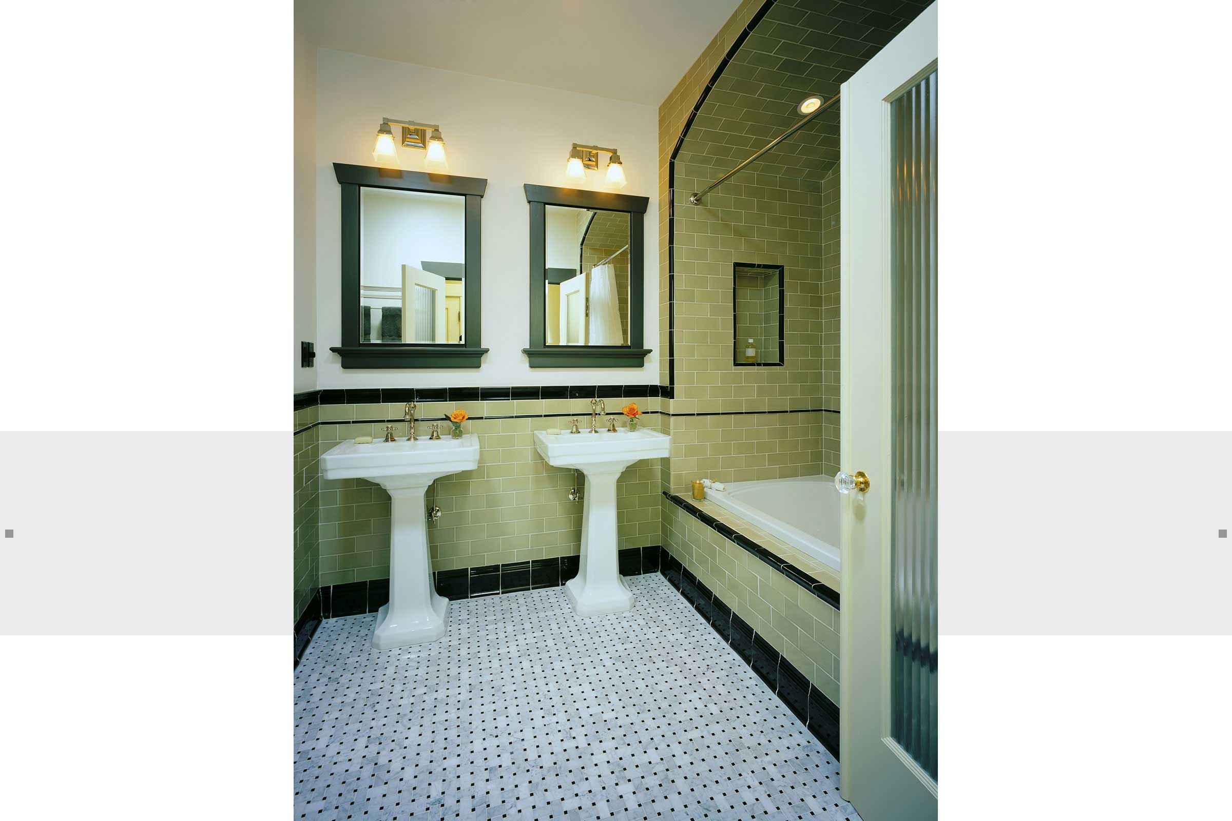bathroom with pedestal sinks and intricate tile work