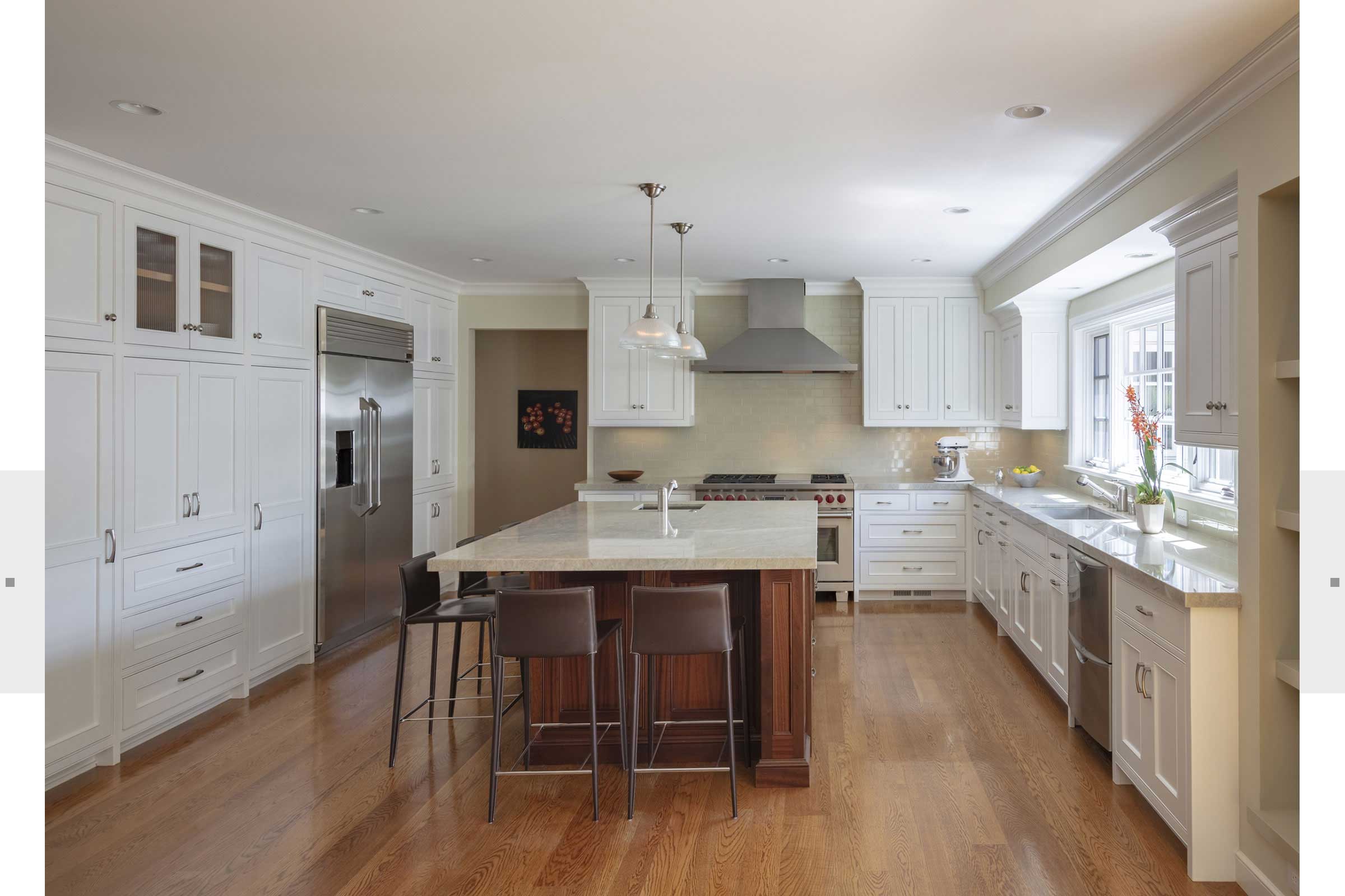 large white kitchen with wood floors