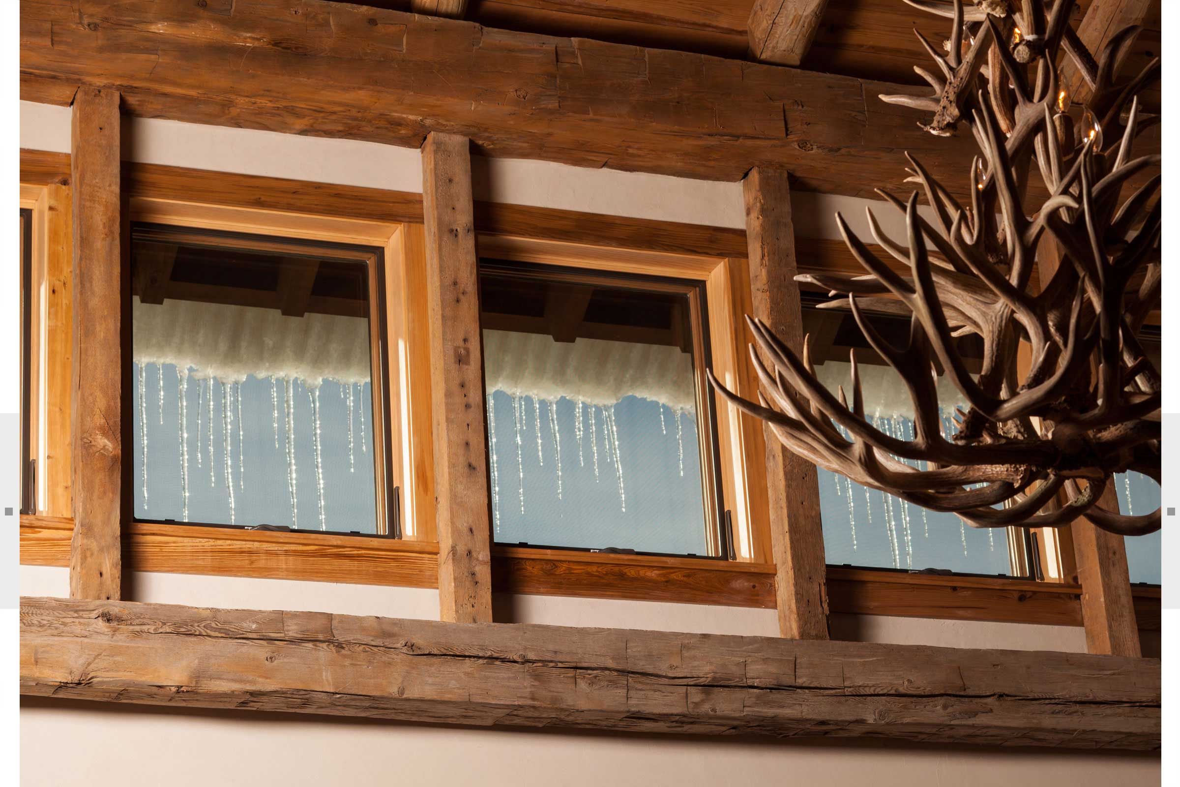 windows with icicles and antler ceiling fixture