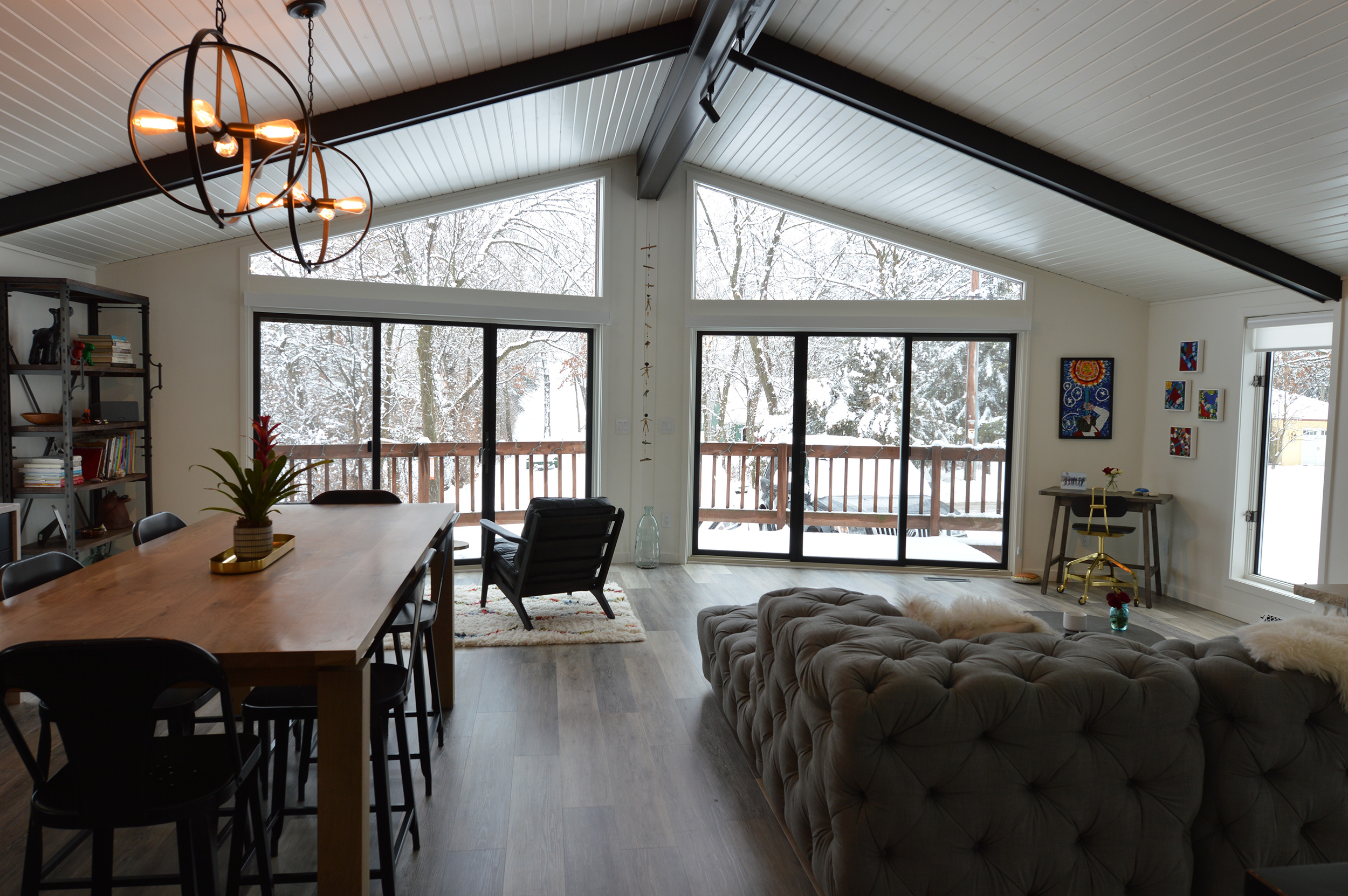 a snowy day as viewed from living and dining area in this remote home